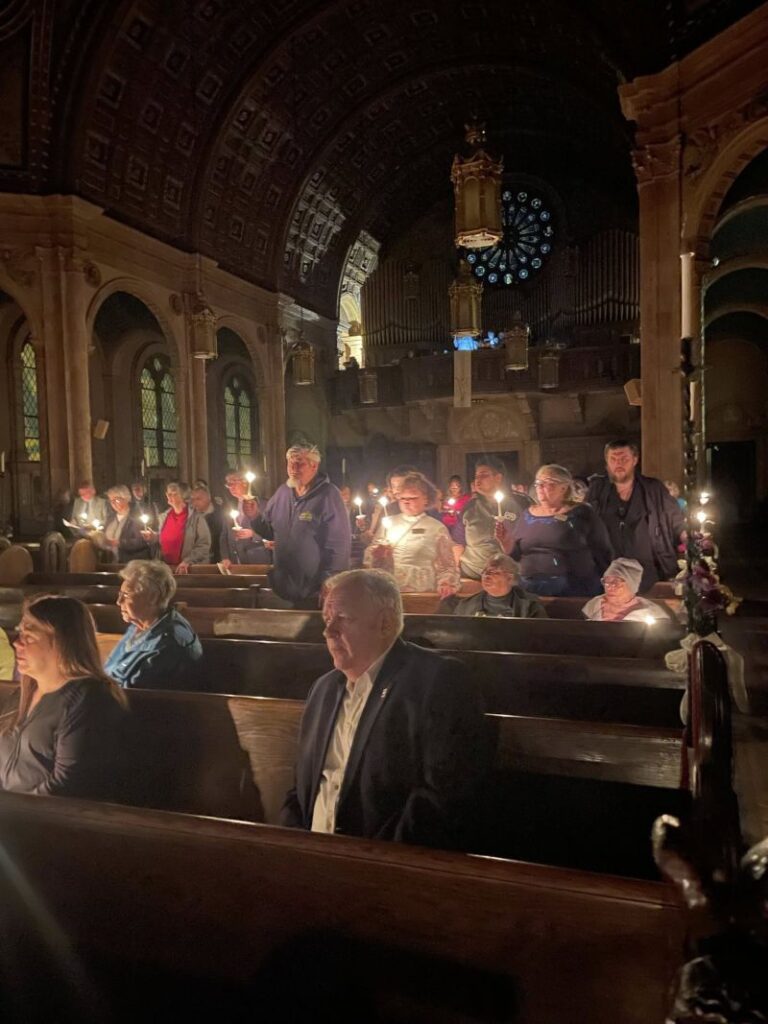 The flock had ignited their own spirits with candles in order to see their way without tripping over themselves at Blessed Trinity on Leroy Avenue