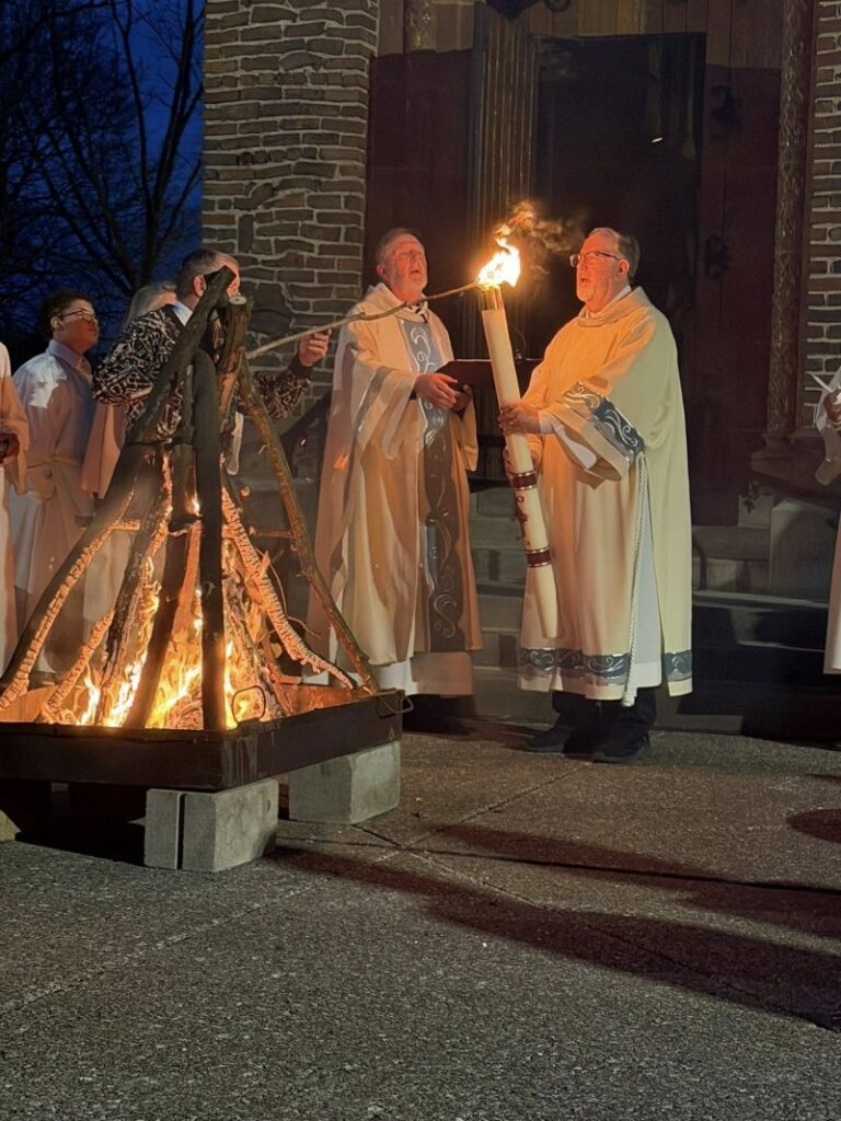 The Easter Candle ignites the passions of the worshipers at Blessed Trinity on Leroy Ave